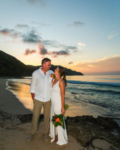 Romantic portrait of the couple standing on the beach at sunset in St. Croix