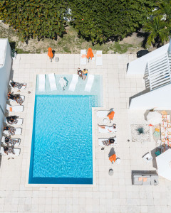 Drone view of Group of friends celebrating a birthday at Seascape villa, St. Croix with large swimming pool