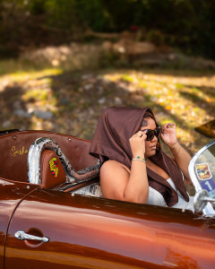 Woman celebrating her birthday sitting in a classic bronze Porsche in St Croix