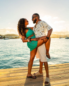 Woman posing with her husband for her birthday at Hotel on the Kay in St Croix at sunset