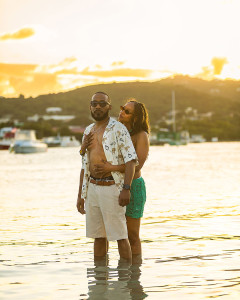 Black couple posing in the sea at sunset in St Croix
