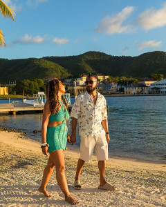 Candid moment of a black couple walking on the beach in St Croix