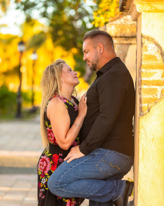 Modern minimalist couple portrait against a textured concrete wall