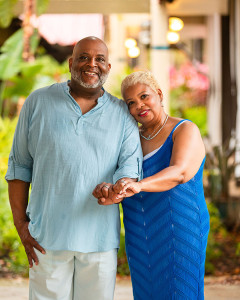 Black couple posing with their wedding rings
