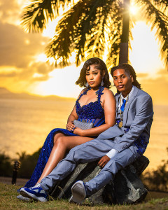 Elegant prom couple posing in formal attire during golden hour