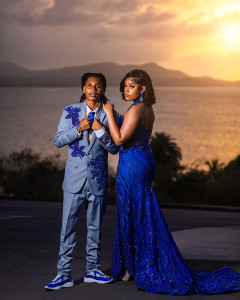 Elegant prom couple posing in formal attire during golden hour