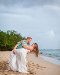 Romantic couple embracing during golden hour sunset engagement session on the beach in St Croix