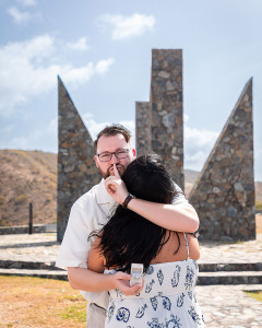 Man tells the photographer to keep the engagement a secret as he tries to surprise his woman.