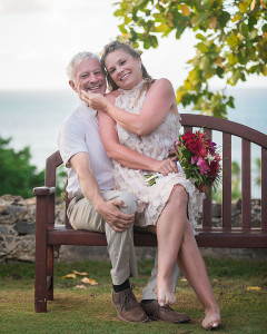 Bride and groom embracing on the garden bench in St Croix